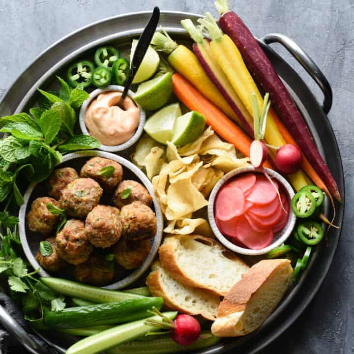 This Banh Mi Meatball Snack Dinner is a healthful platter of fresh ingredients that the whole family will love. Turkey meatballs, fresh and pickled veggies, bread, potato chips and dipping sauce - it's a fun meal that comes together easily. | foxeslovelemons.com