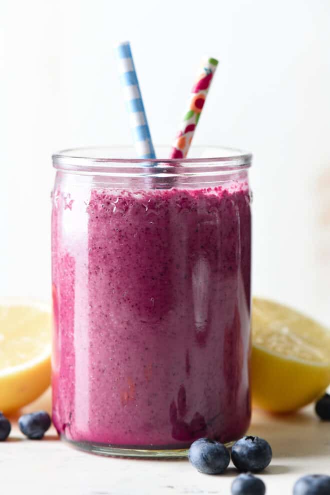 Glass jar of purple beverage with printed paper straws.