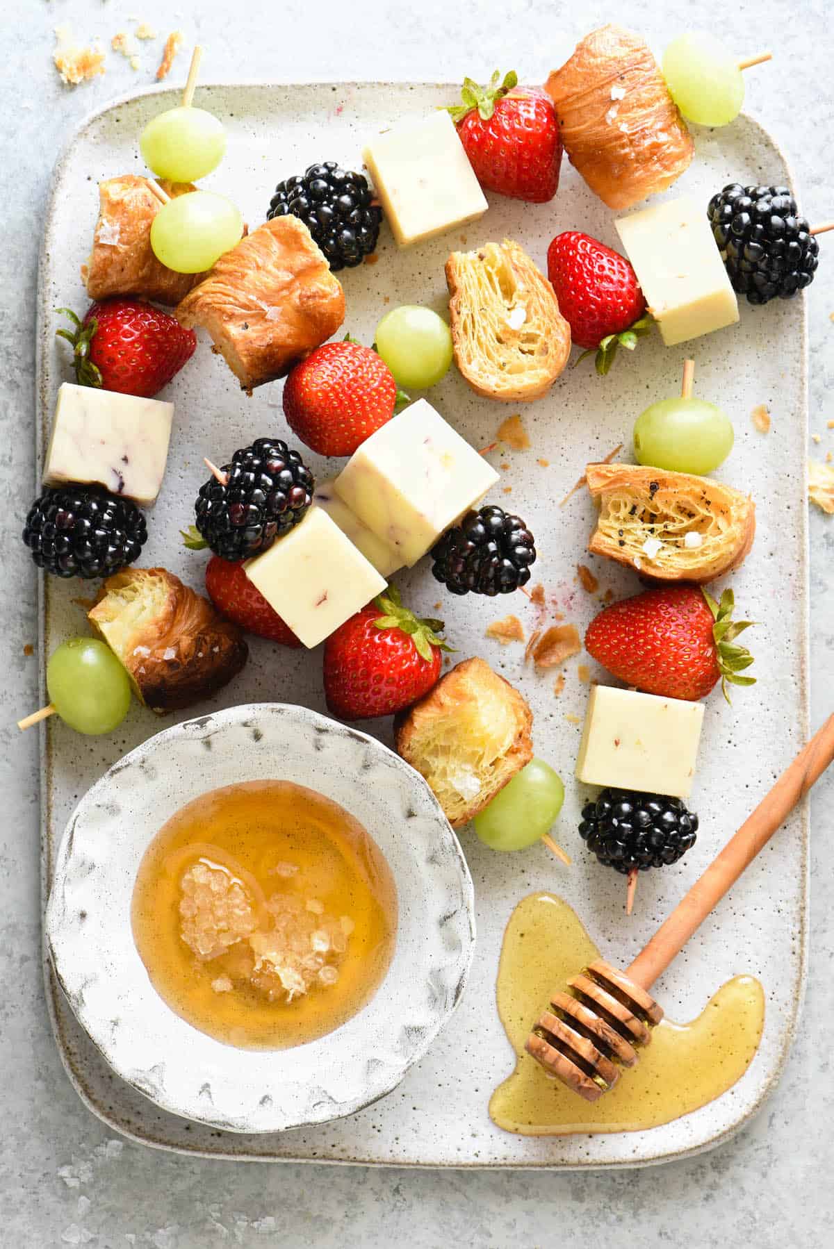 These fresh Fruit and Cheese Kabobs with Croissant Croutons are a nutritious snack that both kids and adults will love. This colorful combination of sweet fruit, savory cheese and flaky croutons comes together in a snap. | foxeslovelemons.com