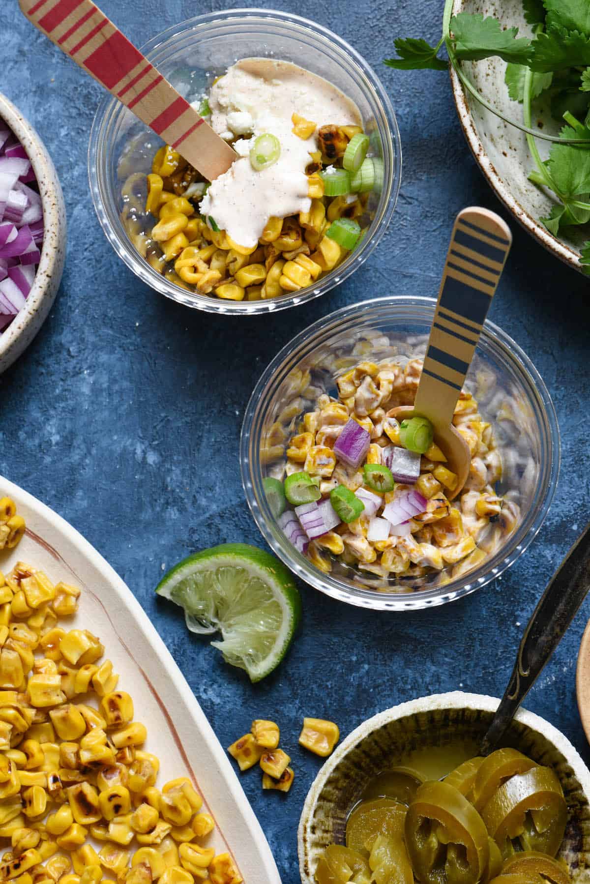 Having a fiesta? Please the whole crowd with this Mexican Street Corn Salad Bar. Gather all of the ingredients for classic Mexican street corn (elote), but let everybody assemble their own. Perfect for the spice lovers, the picky eaters, and the cilantro-adverse! | foxeslovelemons.com