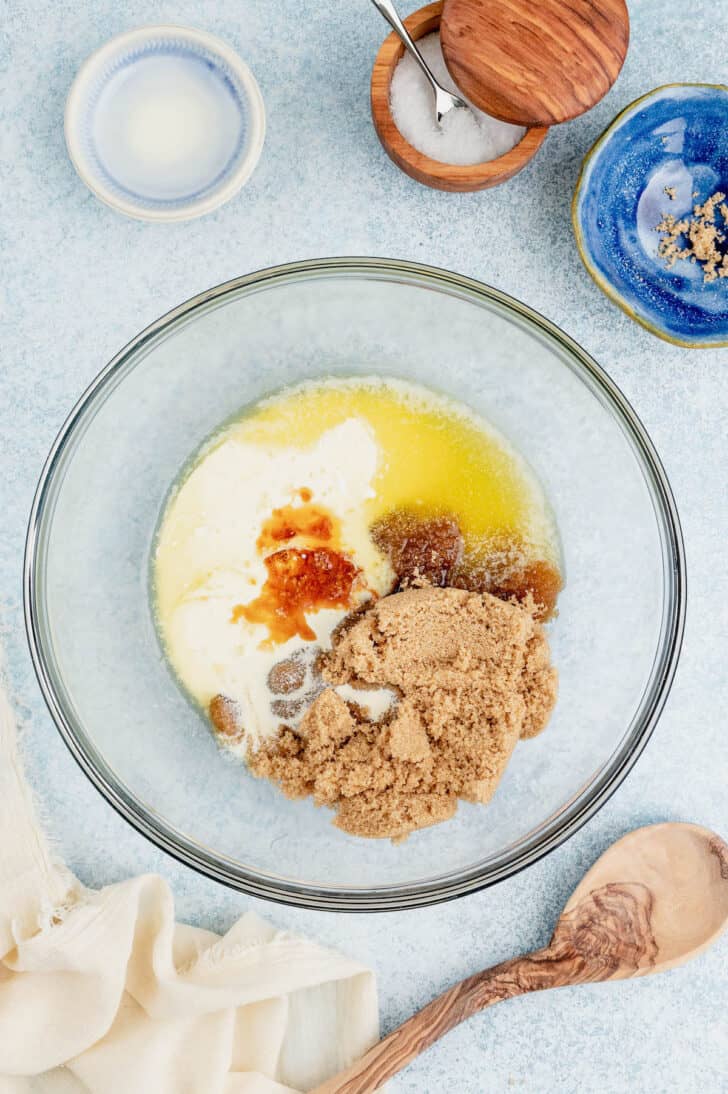 A glass bowl filled with melted butter, brown sugar and vanilla extract.