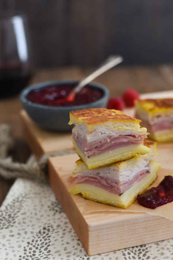 Monte Cristo Party Bites with Raspberry-Malbec Jam - The classic diner sandwich dressed up as a fancy appetizer! Griddled sandwiches filled with ham, turkey and fontina cheese, with a side of homemade jam for dipping! | foxeslovelemons.com