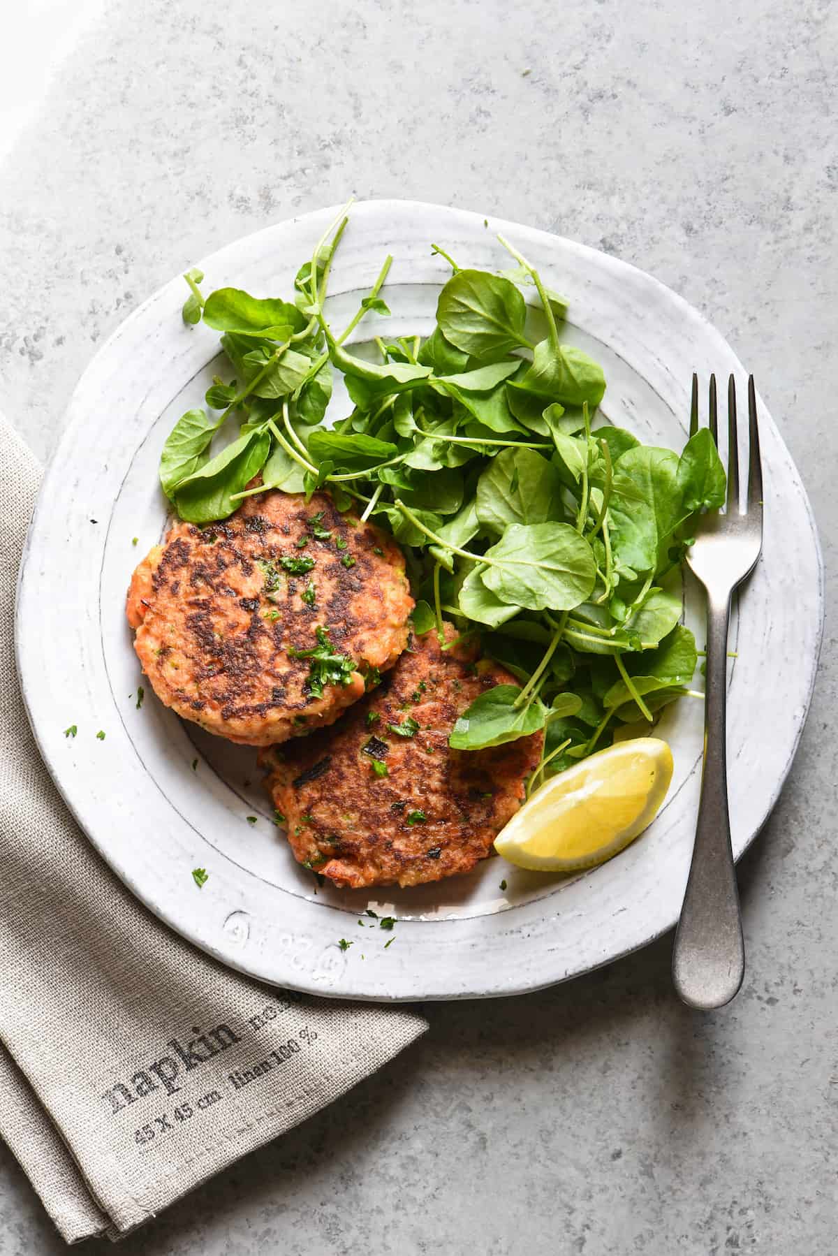 These Salmon Cakes are made with fresh, flavorful ingredients and are easy to prepare. This restaurant-quality recipe will win over even the seafood skeptics in your family. | foxeslovelemons.com