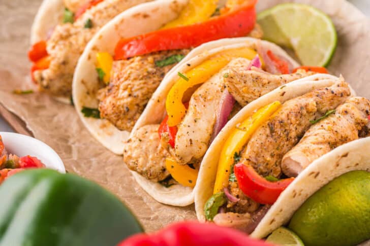 A sheet pan chicken fajitas recipe served in flour tortillas.