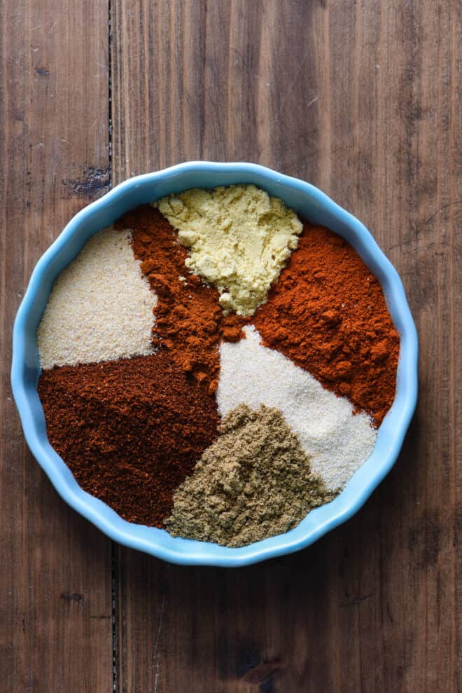 Shallow teal bowl filled with ground spices.