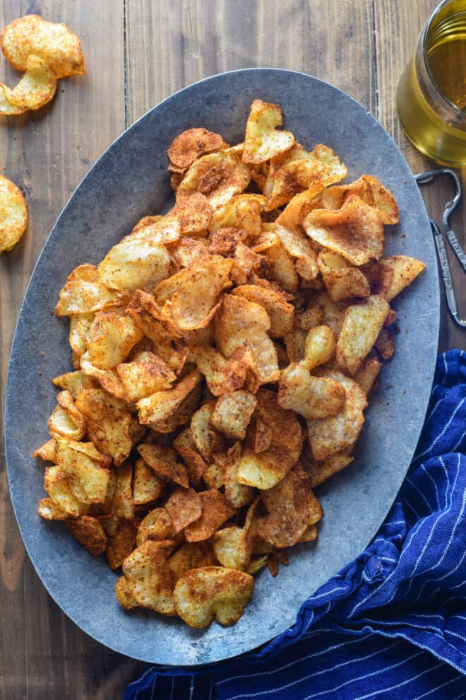 Oval metal plate topped with spicy chips.