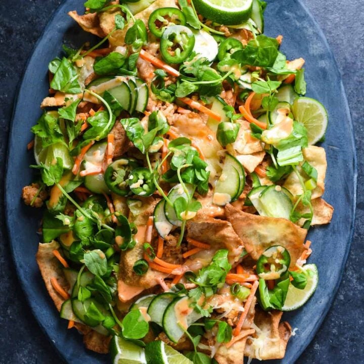 Wonton nachos made from crispy wonton chips, ground pork, pickled veggies, herbs and spicy mayo.